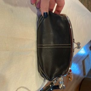 Coach, black wristlet purse with snap shut.
